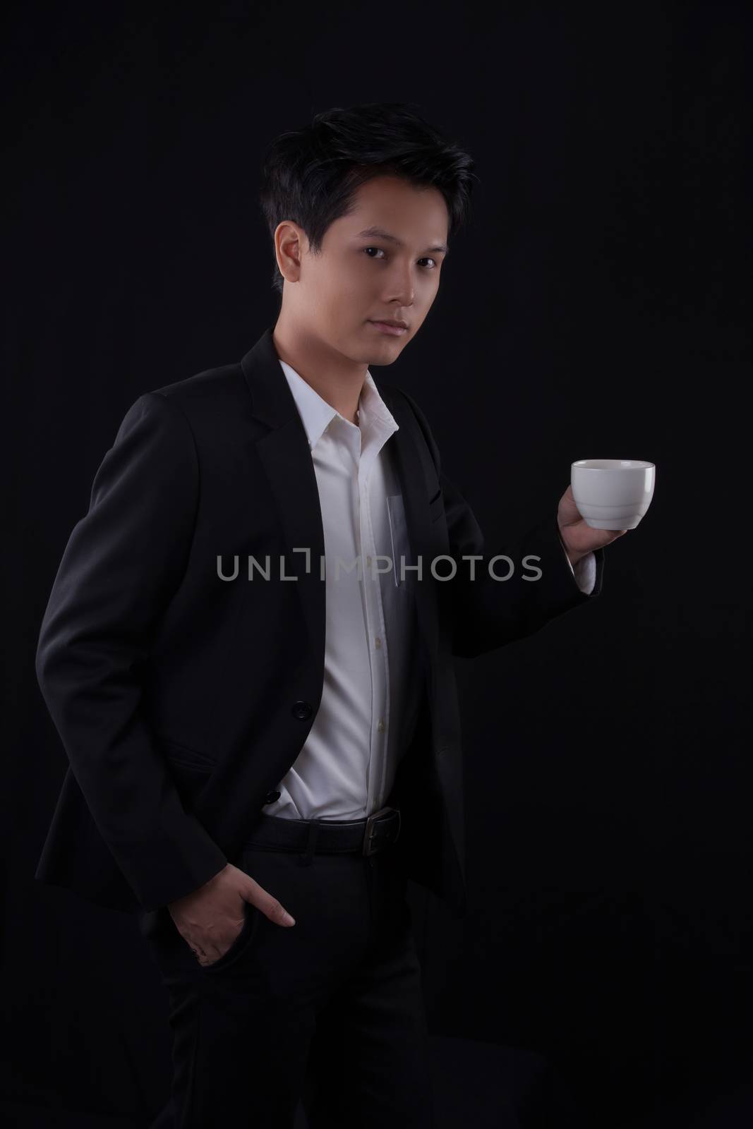 Portrait of Asian young man on black background