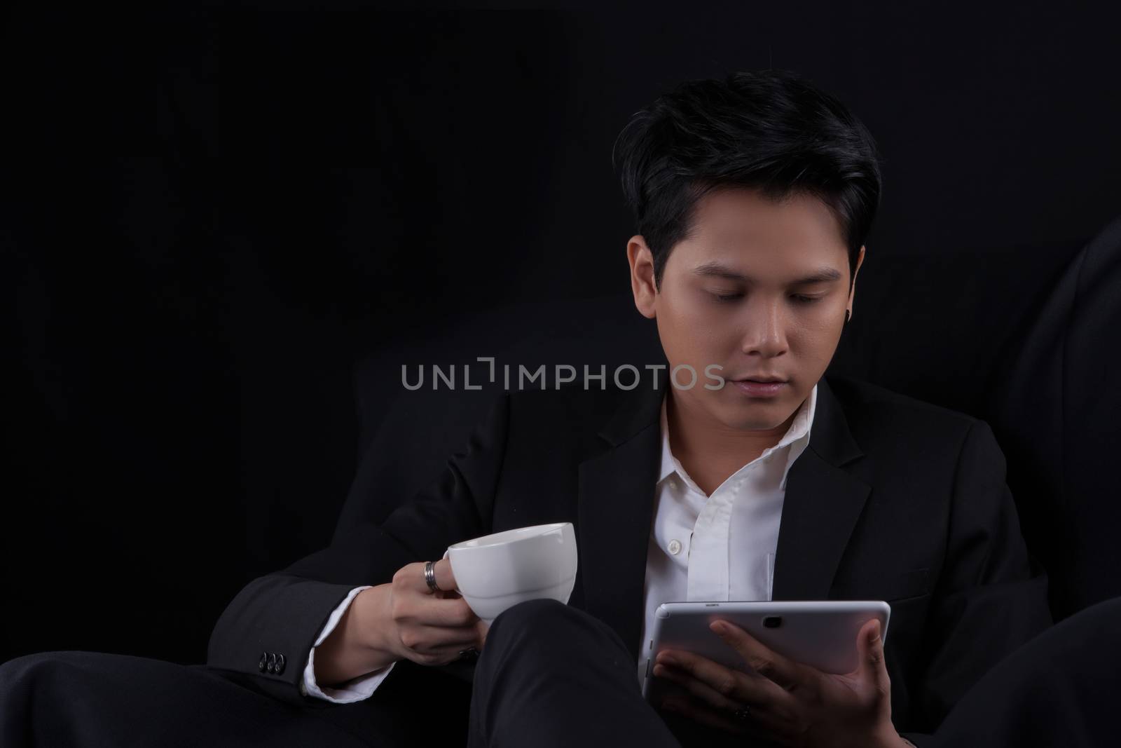 Portrait of Asian young man on black background