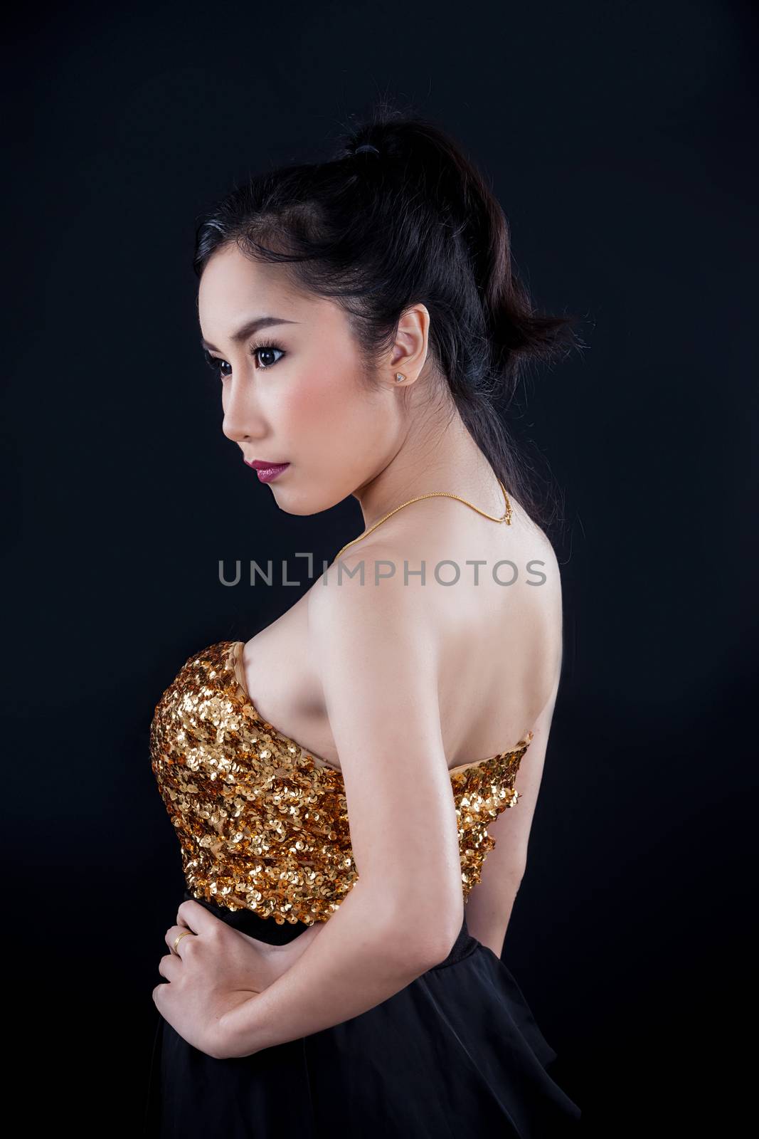 Portrait of beautiful Asian young girl on black background