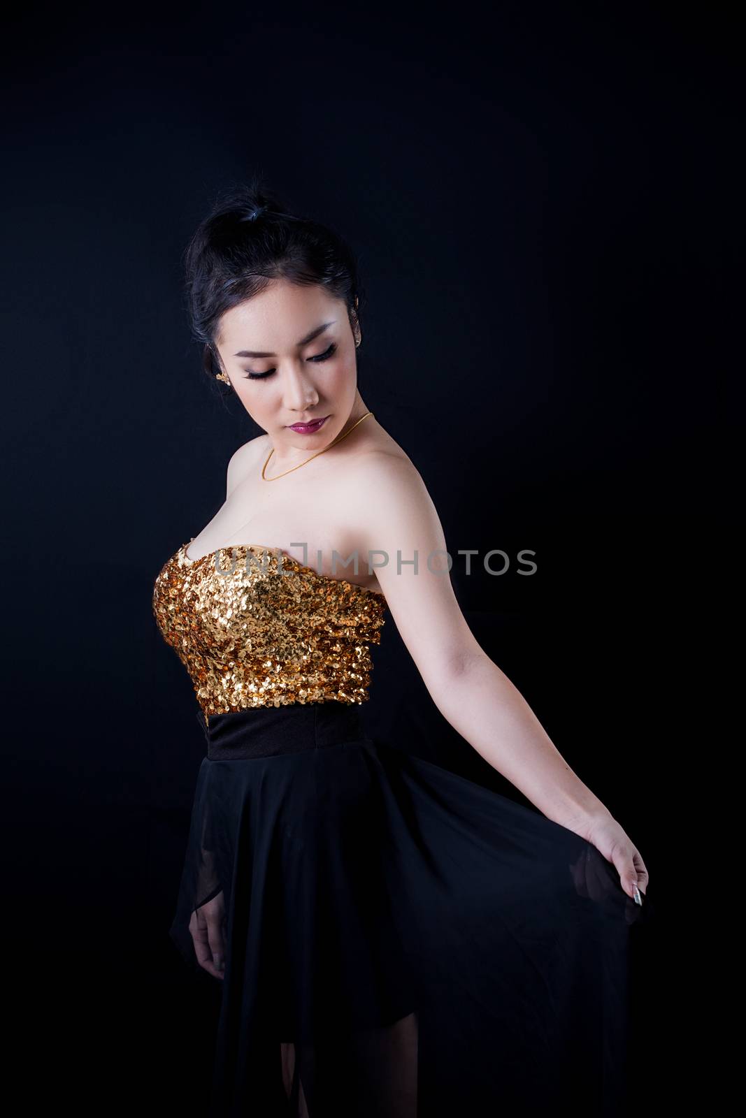 Portrait of beautiful Asian young girl on black background