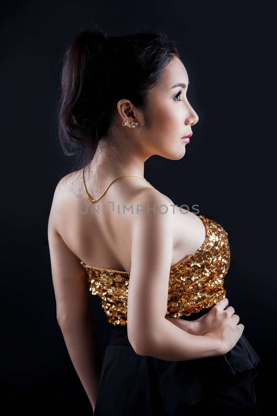 Portrait of beautiful Asian young girl on black background