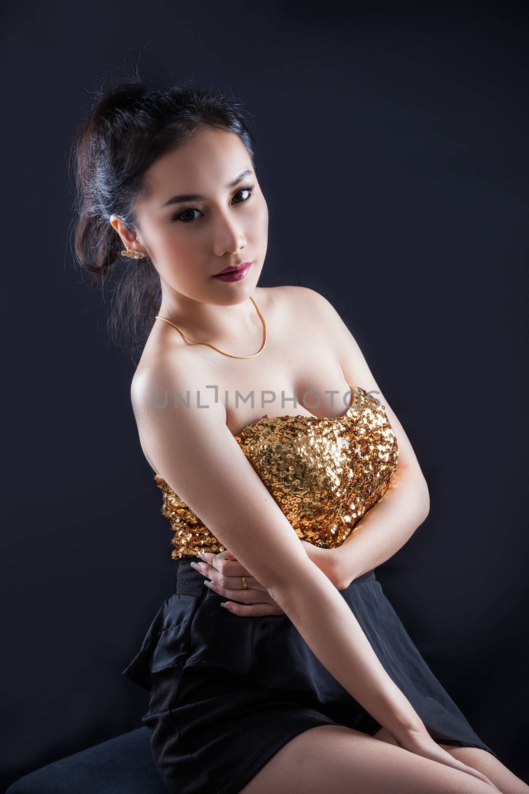 Portrait of beautiful Asian young girl on black background