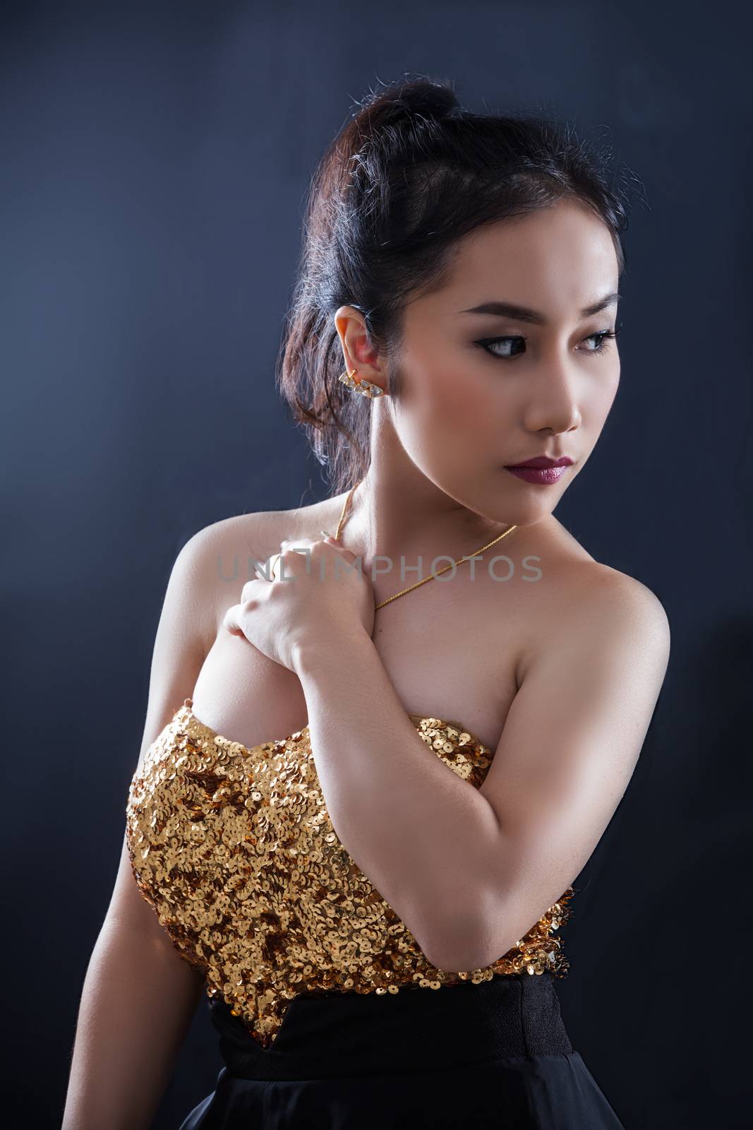 Portrait of beautiful Asian young girl on black background