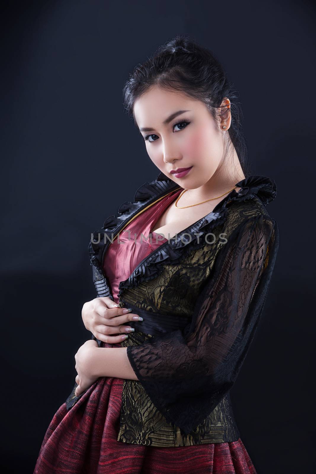 Portrait of beautiful Asian young girl on black background