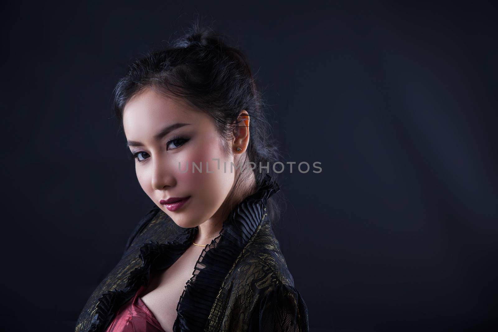 Portrait of beautiful Asian young girl on black background