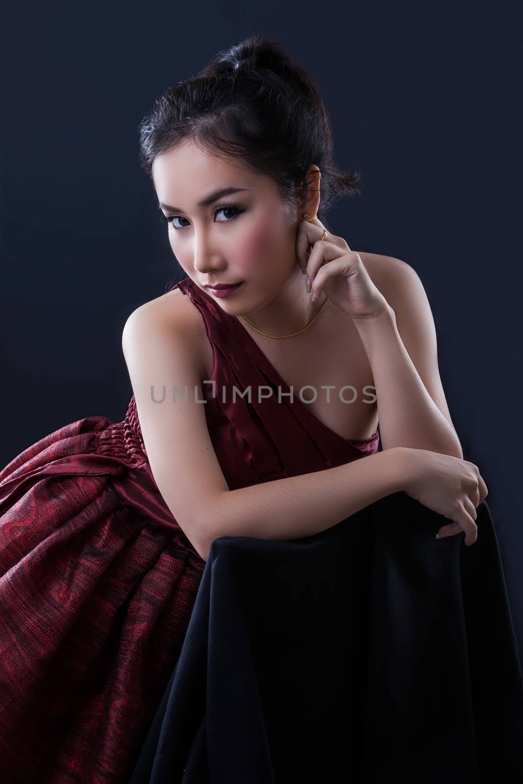 Portrait of beautiful Asian young girl on black background