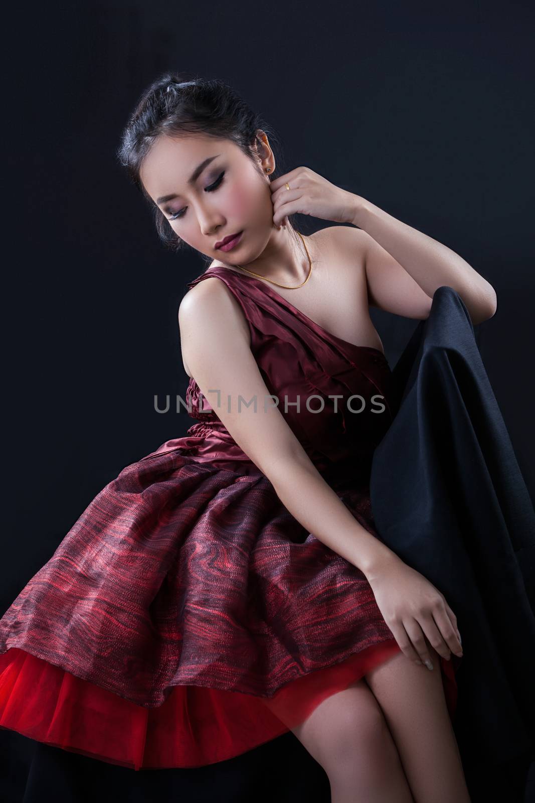 Portrait of beautiful Asian young girl on black background