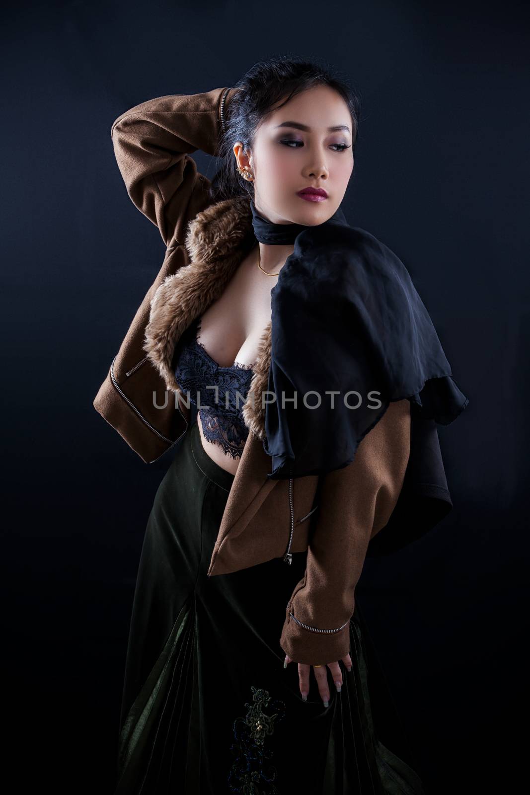 Portrait of beautiful Asian young girl on black background