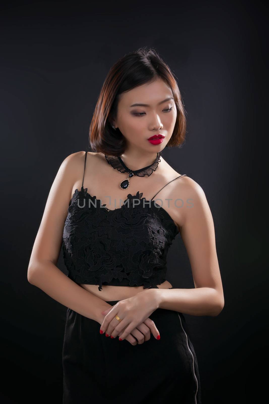 Portrait of beautiful Thai young girl on black background
