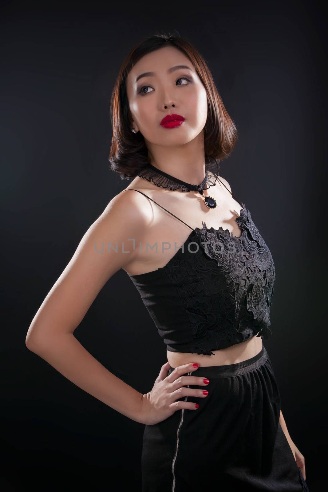 Portrait of beautiful Thai young girl on black background