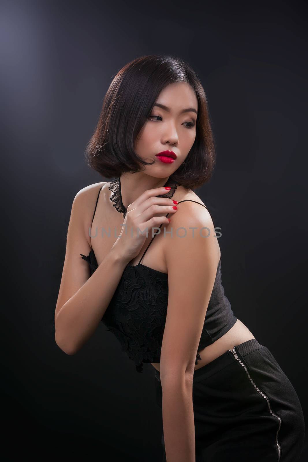 Portrait of beautiful Thai young girl on black background