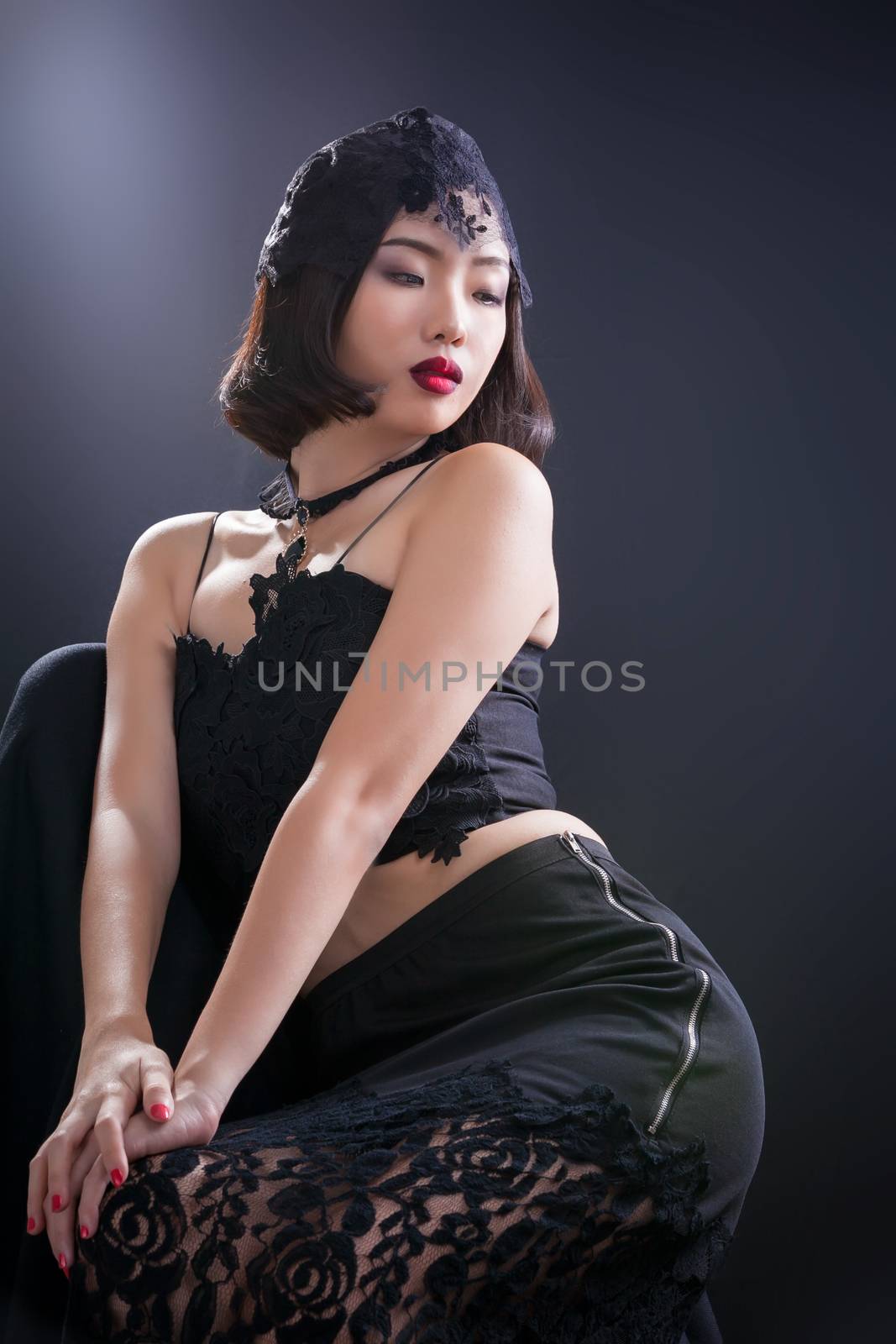 Portrait of beautiful Thai young girl on black background