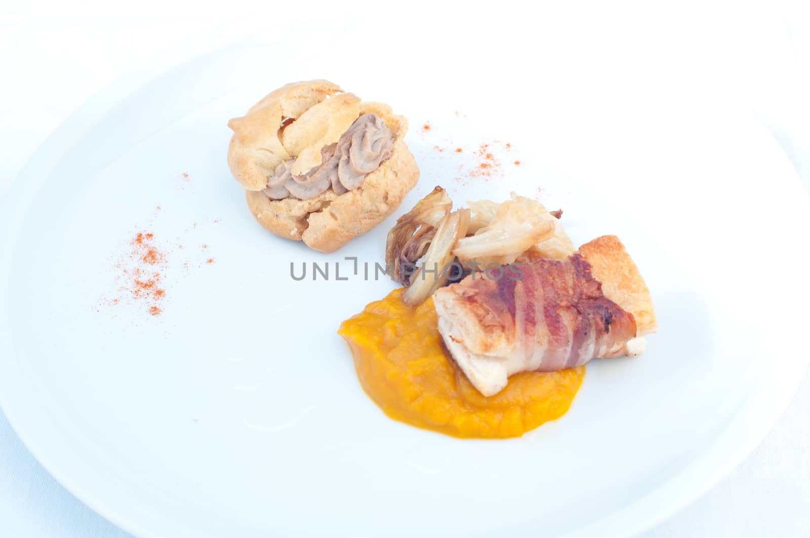 Typical Italian appetizer with liver pate and bacon