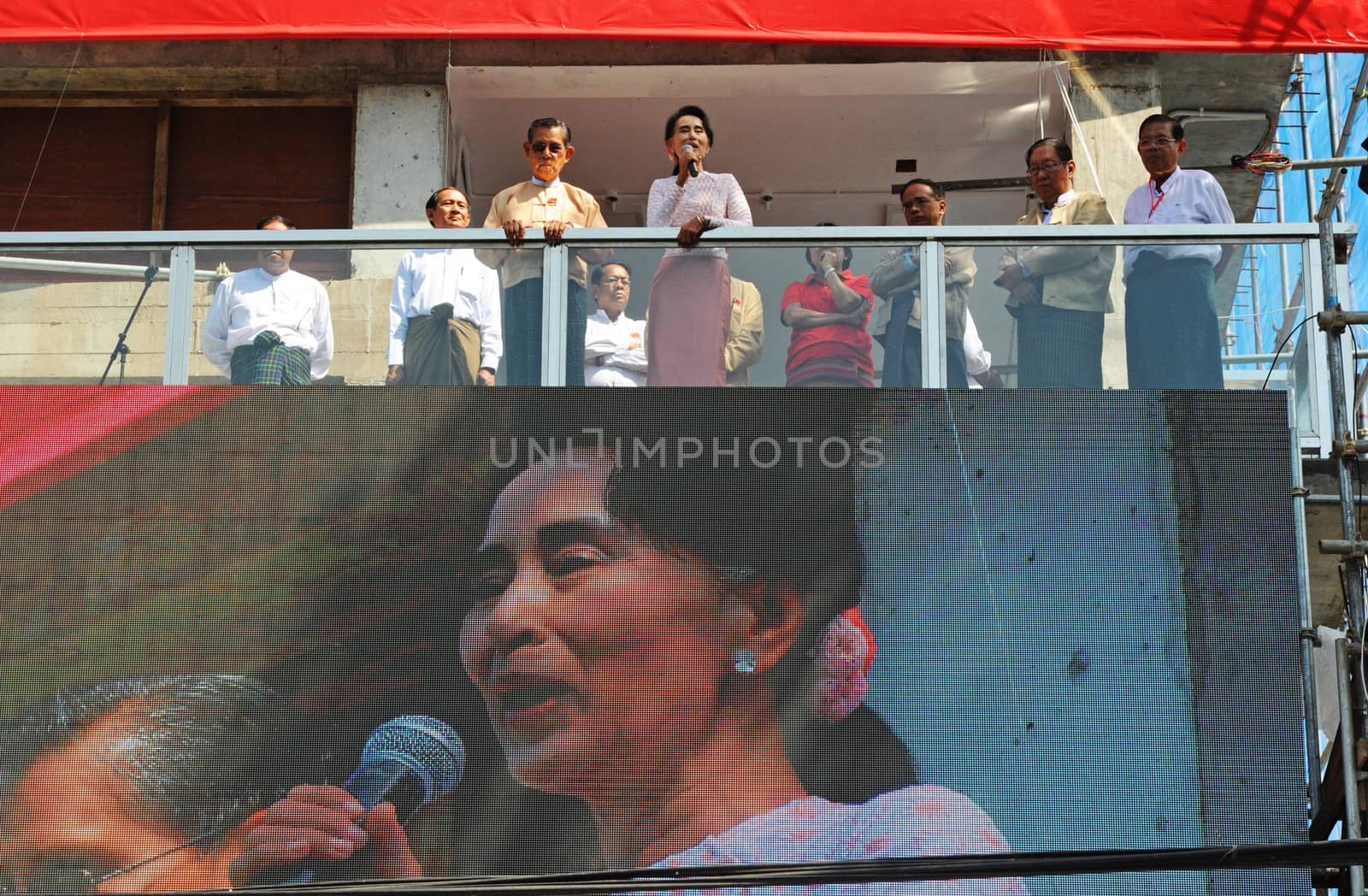 MYANMAR, Yangon: Myanmar opposition leader Aung San Suu Kyi (C), flanked by party patron Tin Oo (3rd L) and other party officials, delivers a speech from the balcony of the National League of Democracy (NLD) headquarters in Yangon on November 9, 2015. Aung San Suu Kyi's opposition party November 9 said they are on course to claim more than 70 percent of seats after Myanmar's poll, a gain that could bring a major power shift from the military. 