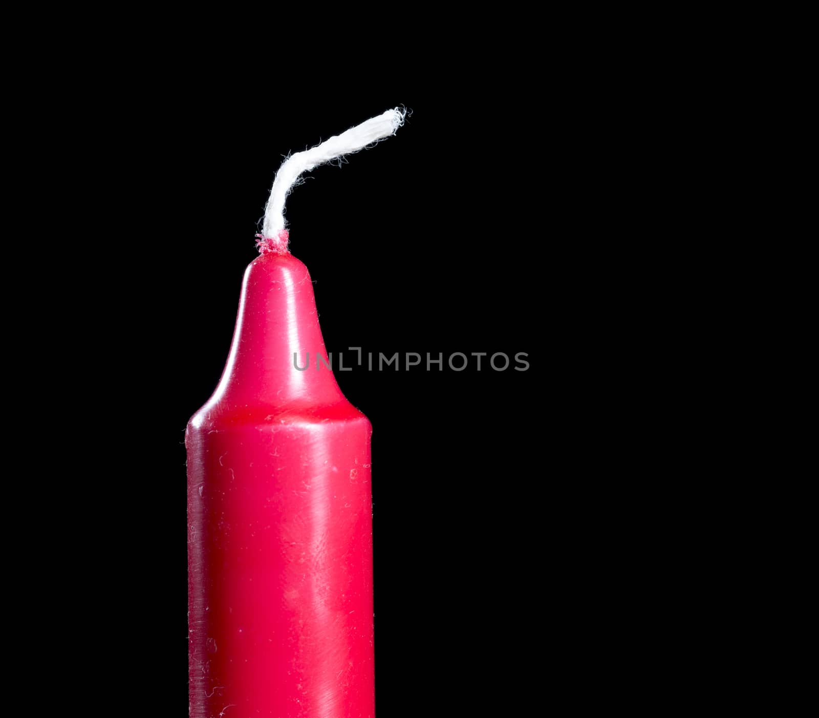 Red Candle Stick Close Up on black background.