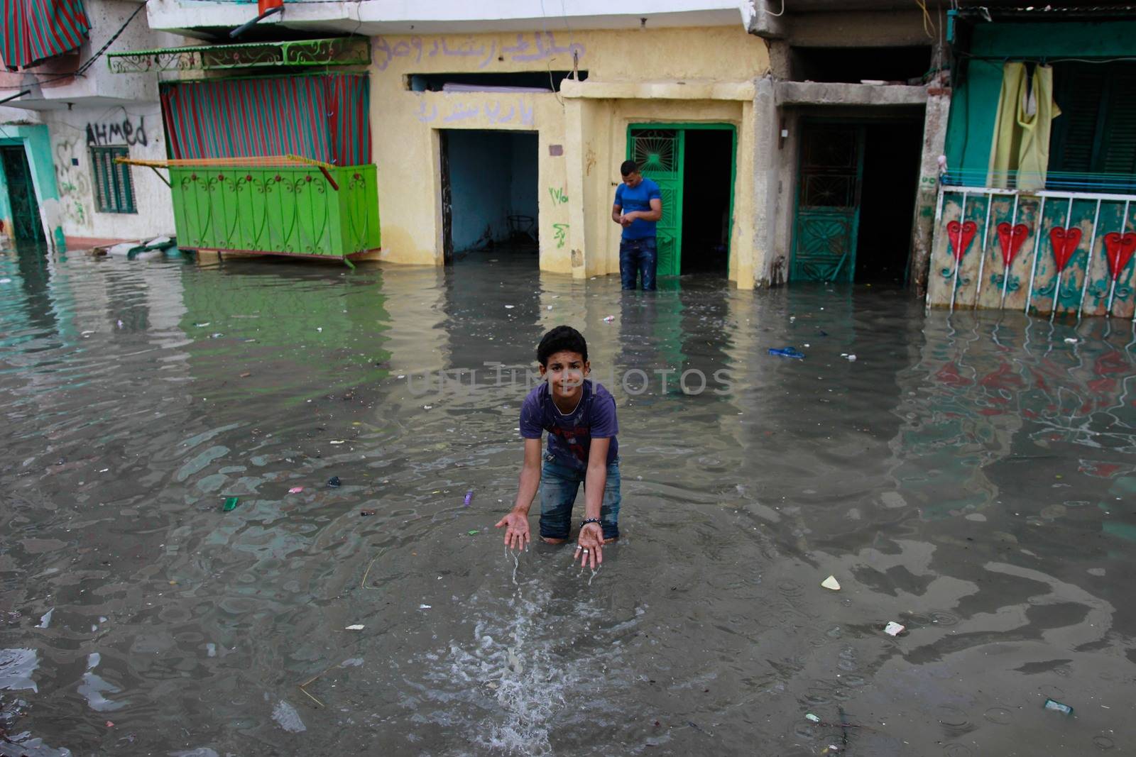EGYPT, Alexandria: People are seen in the flooding road after a torrential rain caused flood in the Kafr El Arab neigborhood in west of Alexandria, Egypt on November 07, 2015.
