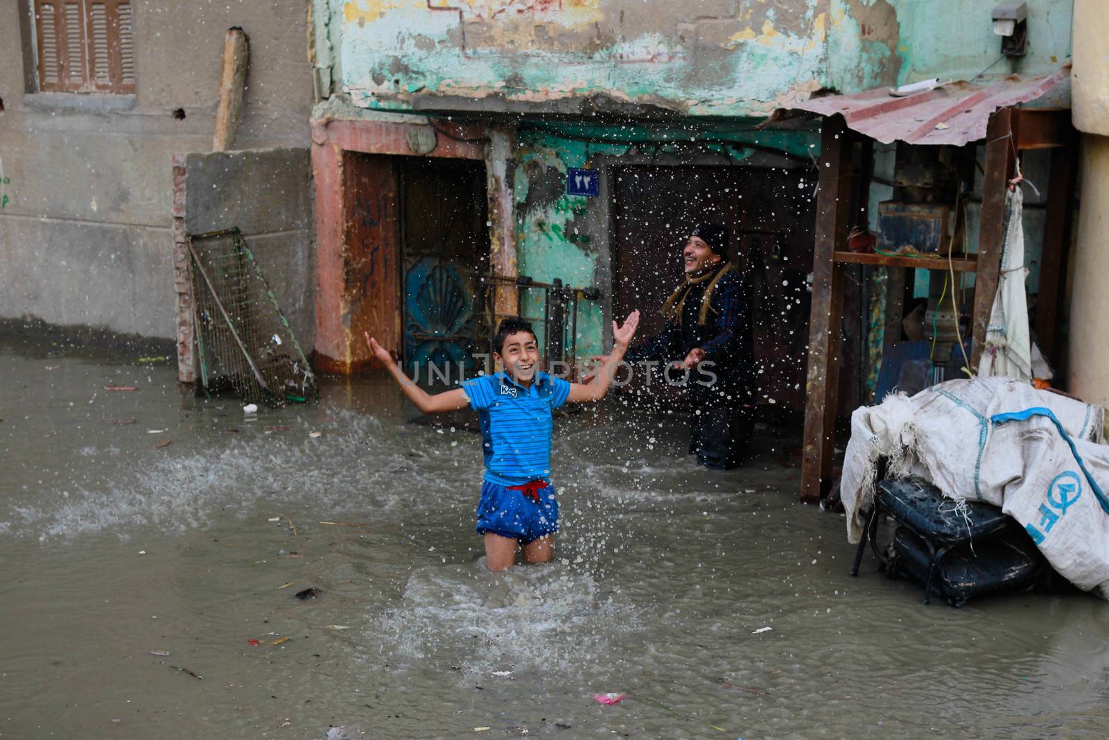 EGYPT, Alexandria: People are seen in the flooding road after a torrential rain caused flood in the Kafr El Arab neigborhood in west of Alexandria, Egypt on November 07, 2015.