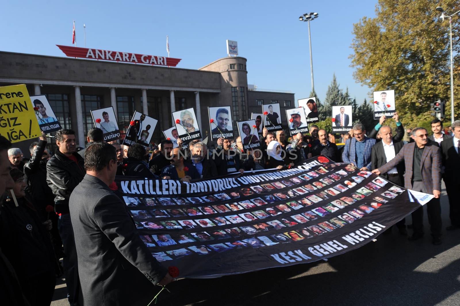 TURKEY, Ankara: Mourners hold a banner with the faces of victims of the October 10 bombings during a ceremony in Ankara, Turkey on November 7, 2015, honoring the victims. The twin explosions left at least 97 people dead and more than 400 others injured on October 10.