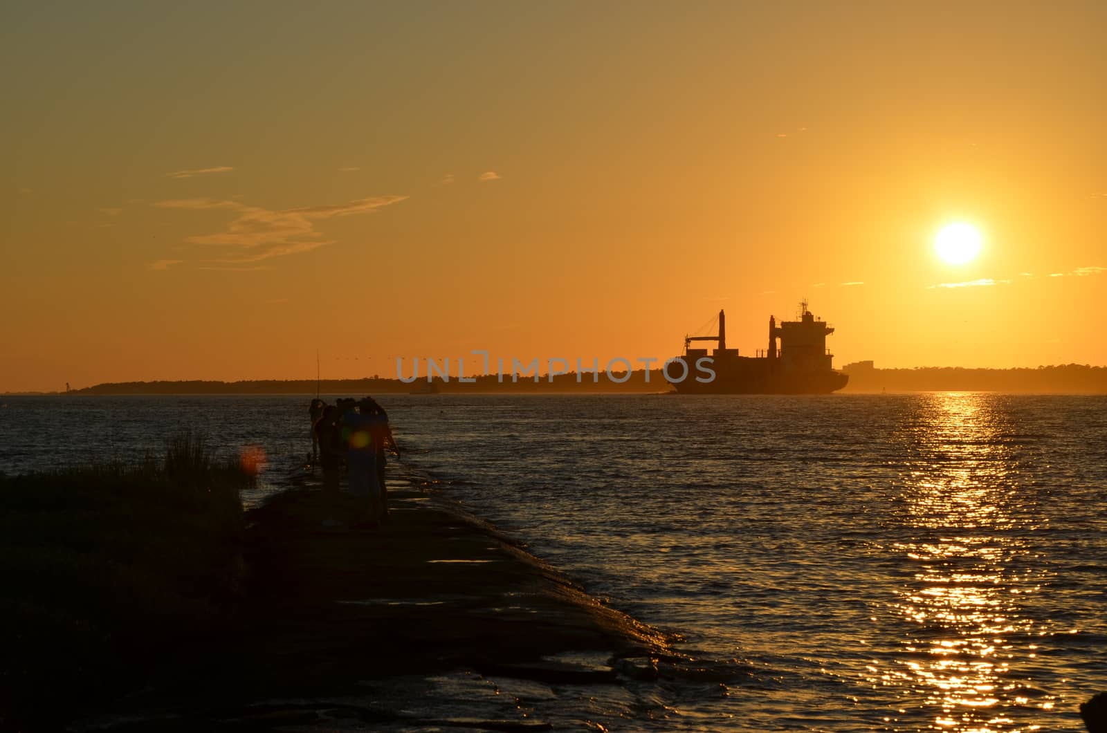 A ship heading into the fading sun. Shot taken along the Cape Fear River in North Carolina.