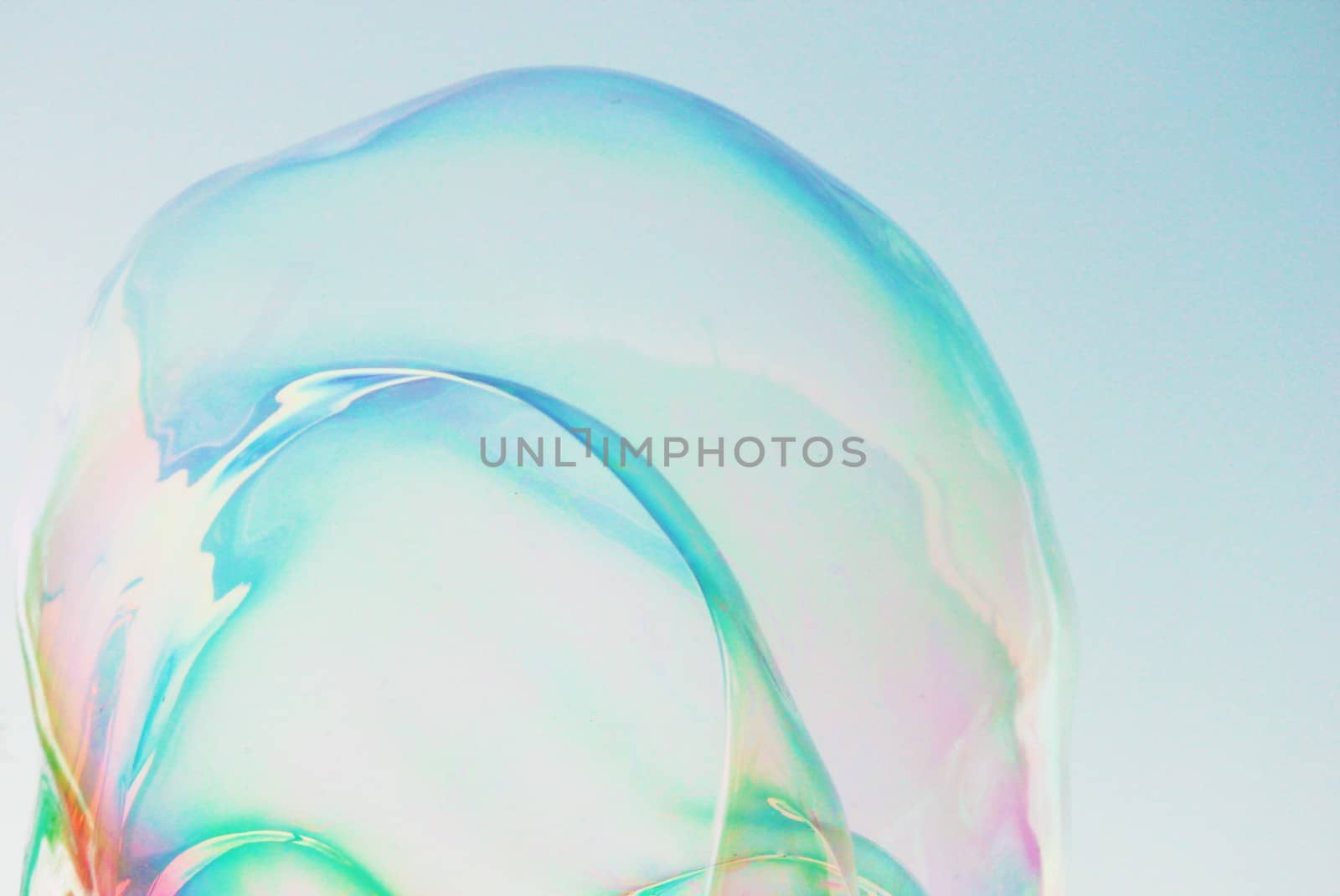 Soap bubbles on a blue sky illuminated by the sun by cheekylorns