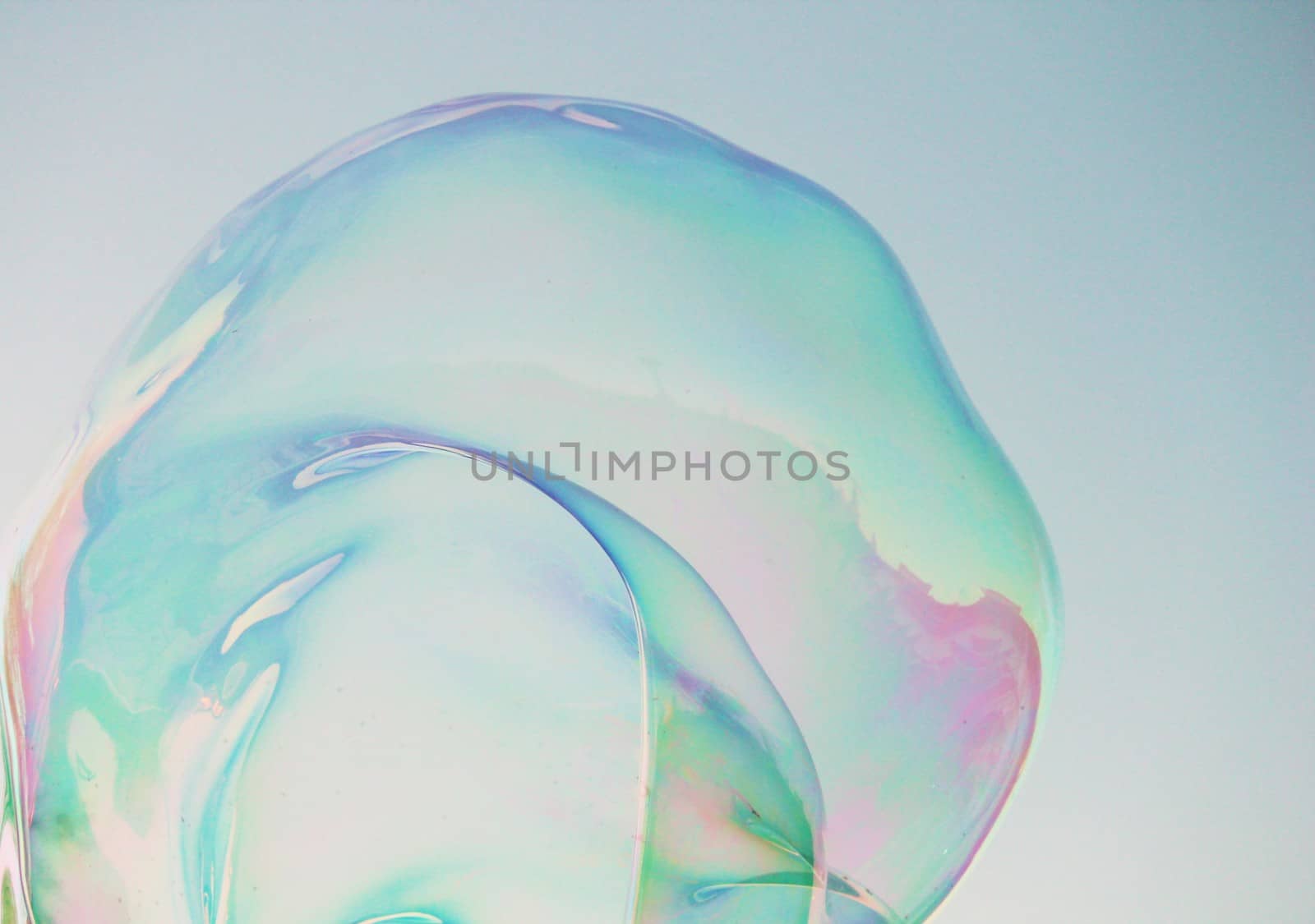 Soap bubbles on a blue sky illuminated by the sun texture background with copyspace