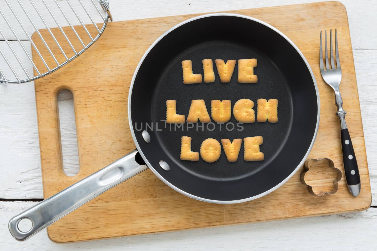 Letter cookies word LIVE LAUGH LOVE and kitchen utensils by vinnstock