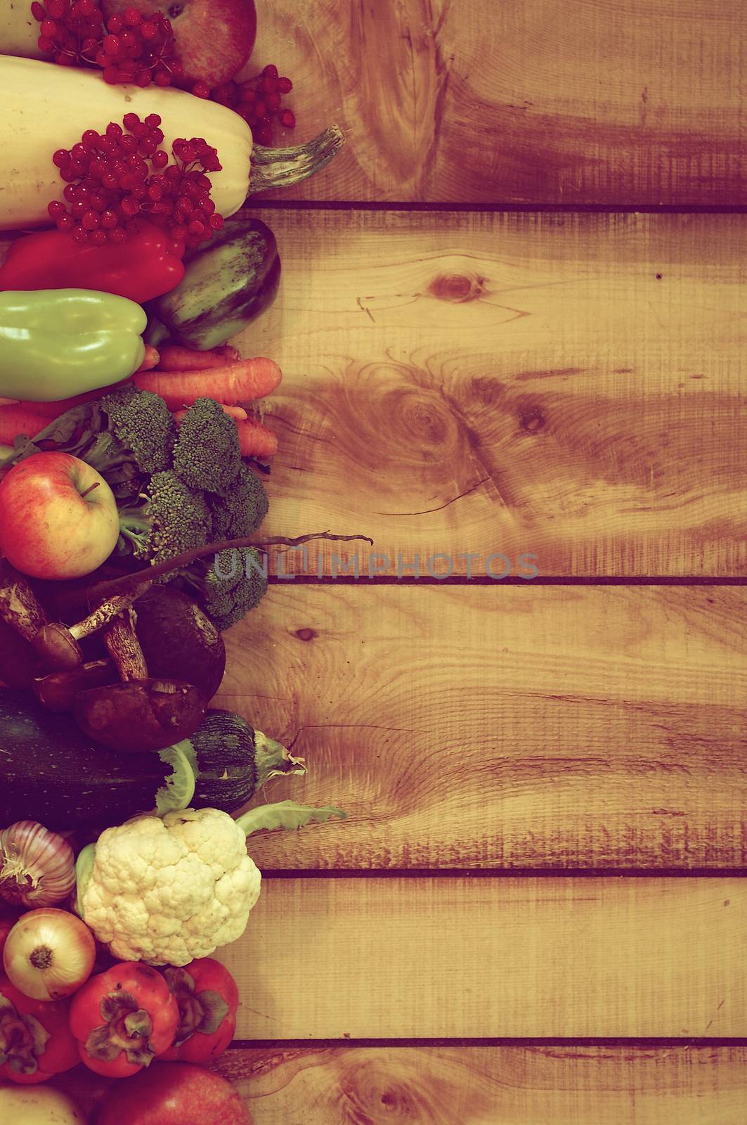 Frame of Various New Harvest Vegetables, Fruits, Roots, Edible Mushrooms and Berries closeup on Wooden background. Retro Styled