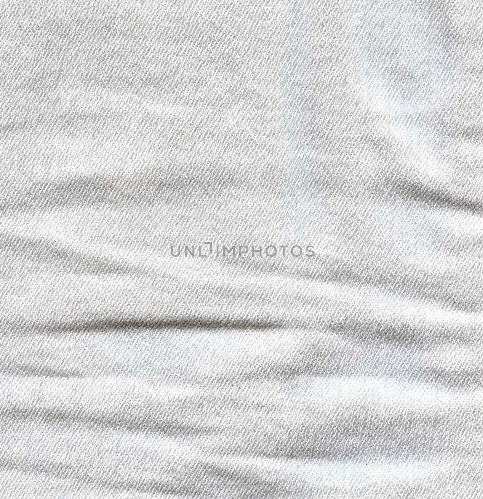 Light crumpled jeans background. Creased denim surface. White gray color canvas texture 