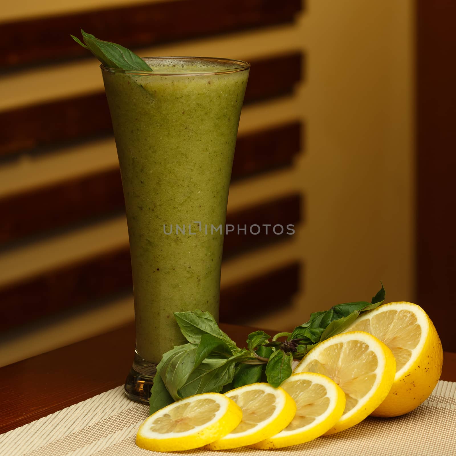 Glass of sweet smoothie and ingredients on the table