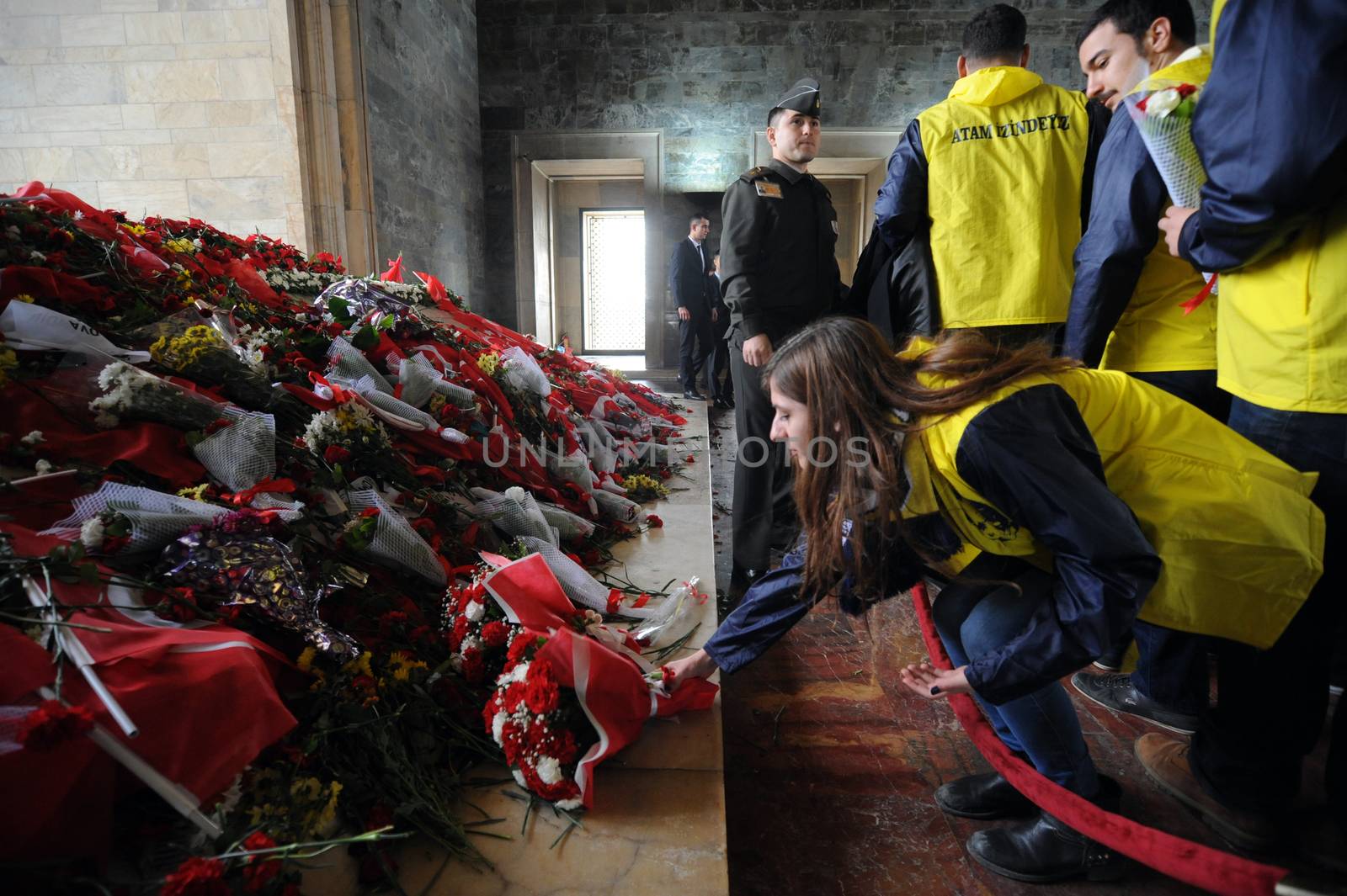 TURKEY, Ankara : A woman leaves a bouquet of red and white flowers  the colours of the Turkish flag, while thousands flock in front of the mausoleum of Turkish Republic's founder, Mustafa Kemal Atat�rk, to commemorate his 77th death anniversary in Ankara on November 10, 2015.   
