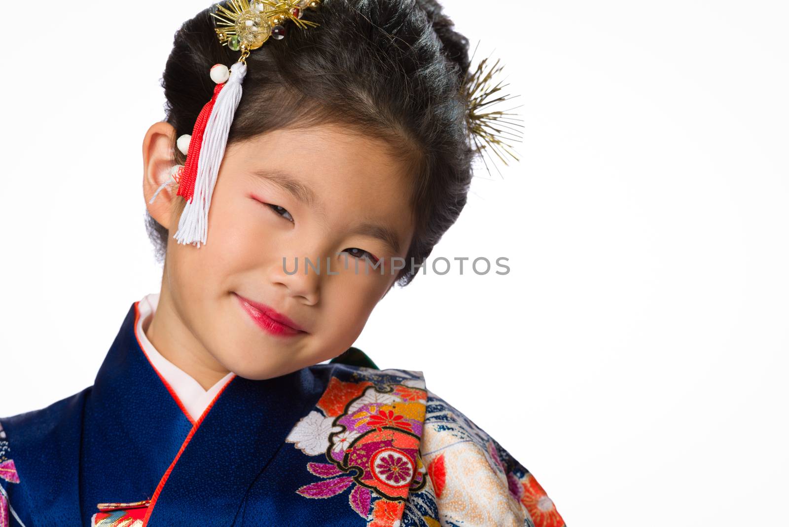 A cute young Japanese girl wearing a Kimono on a white background.