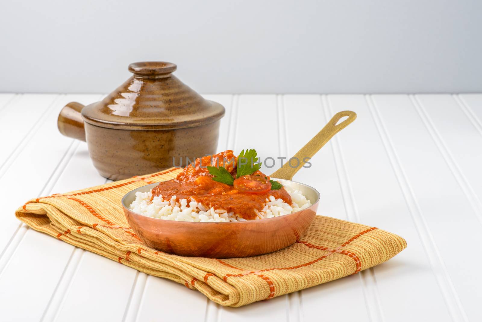 Pan of Indian butter chicken served with white rice.