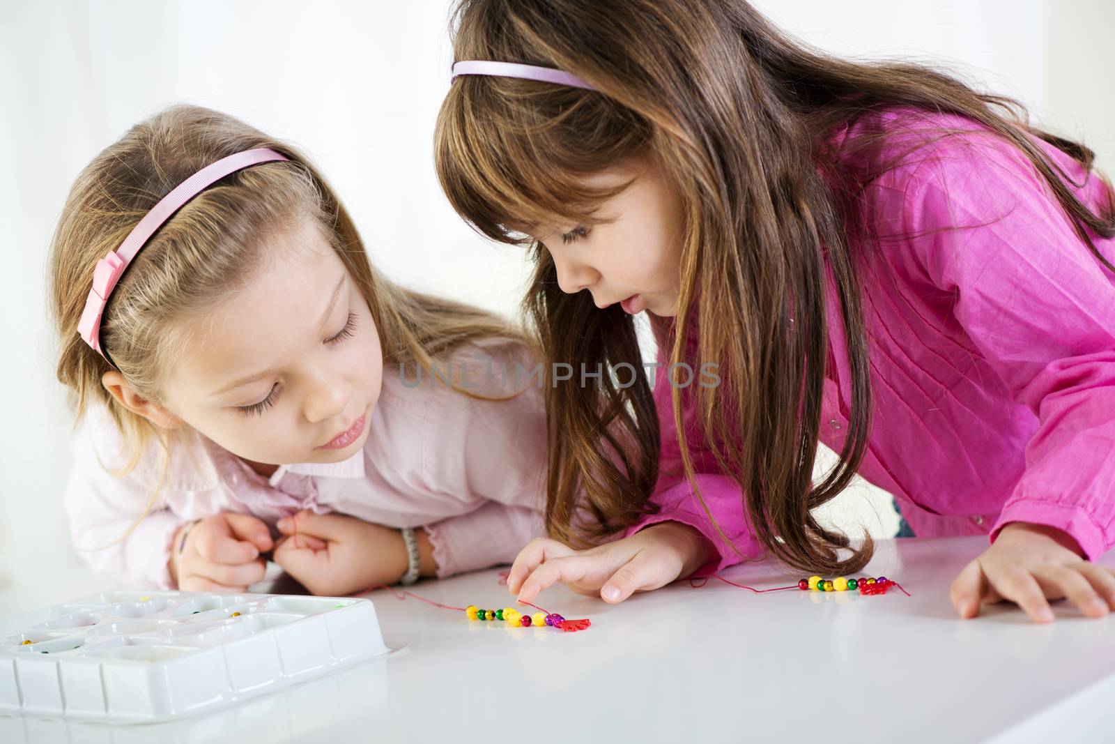 Two cute little girls playing at home.