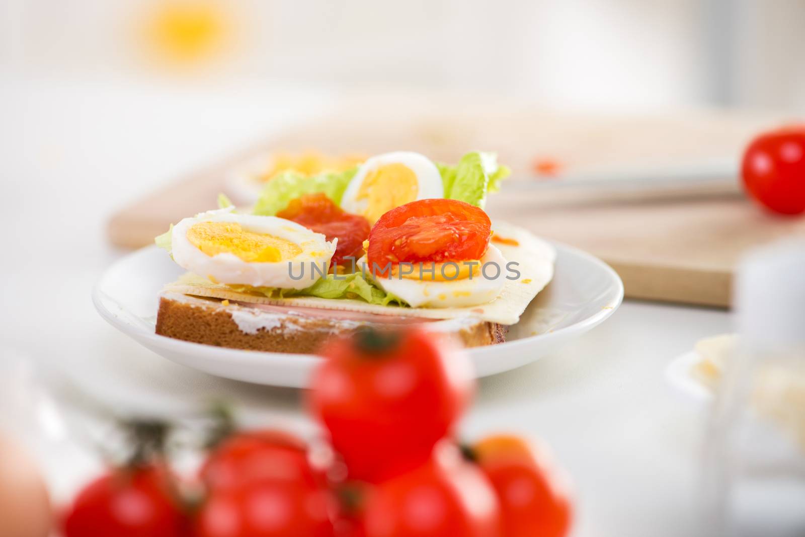 Close up of fresh sandwich with cherry tomato, Lettuce, Cheese and eggs.