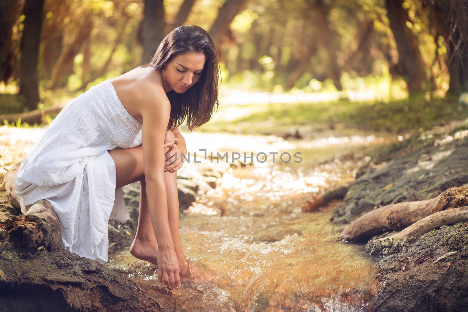 Young beautiful woman relaxing the stream in the nature. 