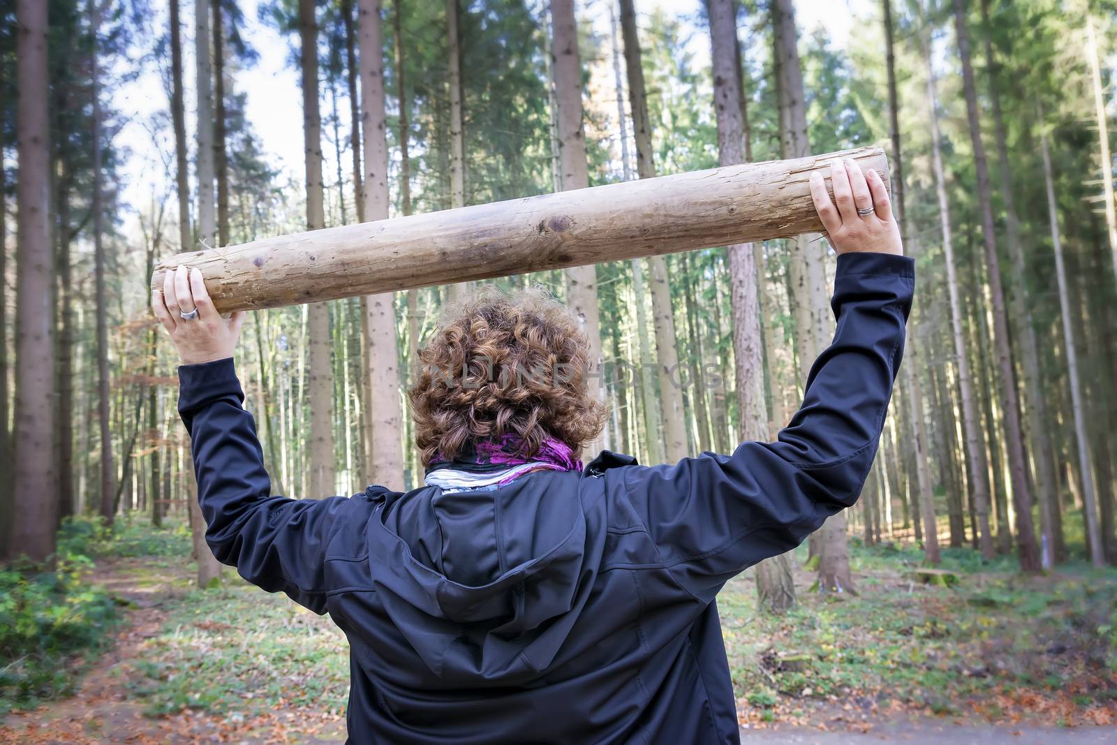 Image of woman is doing fitness exercises in forest