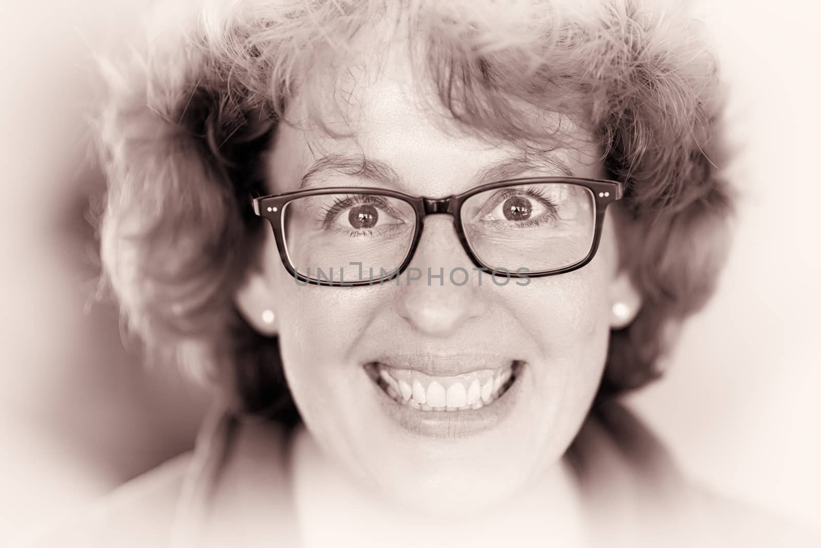 Closeup image of a laughing happy woman with glasses
