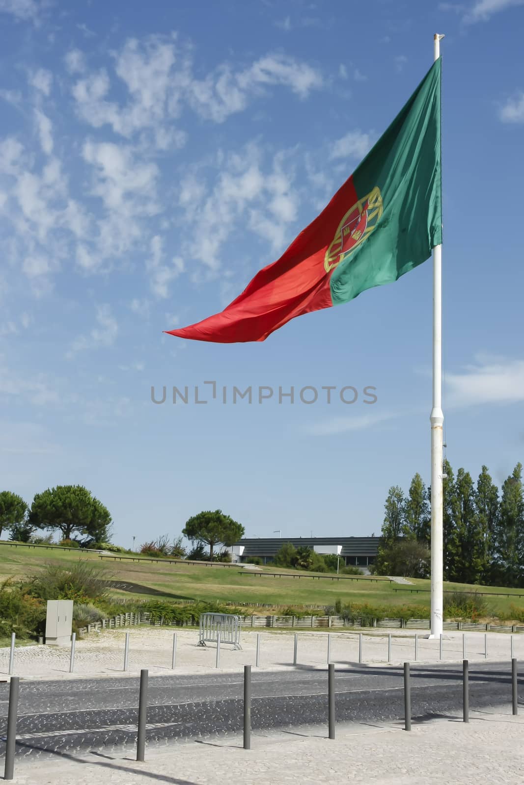 Flag of Portugal waving, against blue sky by mailos