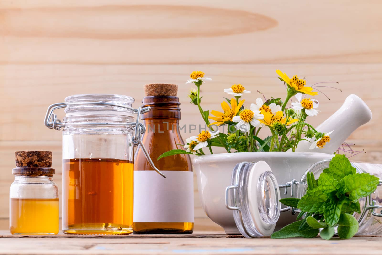 Alternative health care fresh herbal ,honey and wild flower with mortar on wooden background.