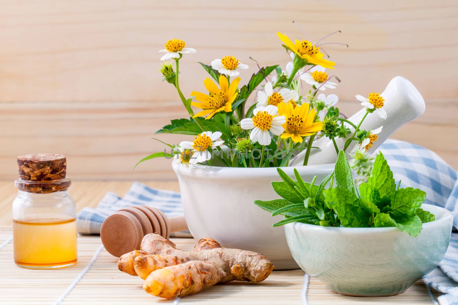 Alternative health care fresh herbal ,honey and wild flower with mortar on wooden background.