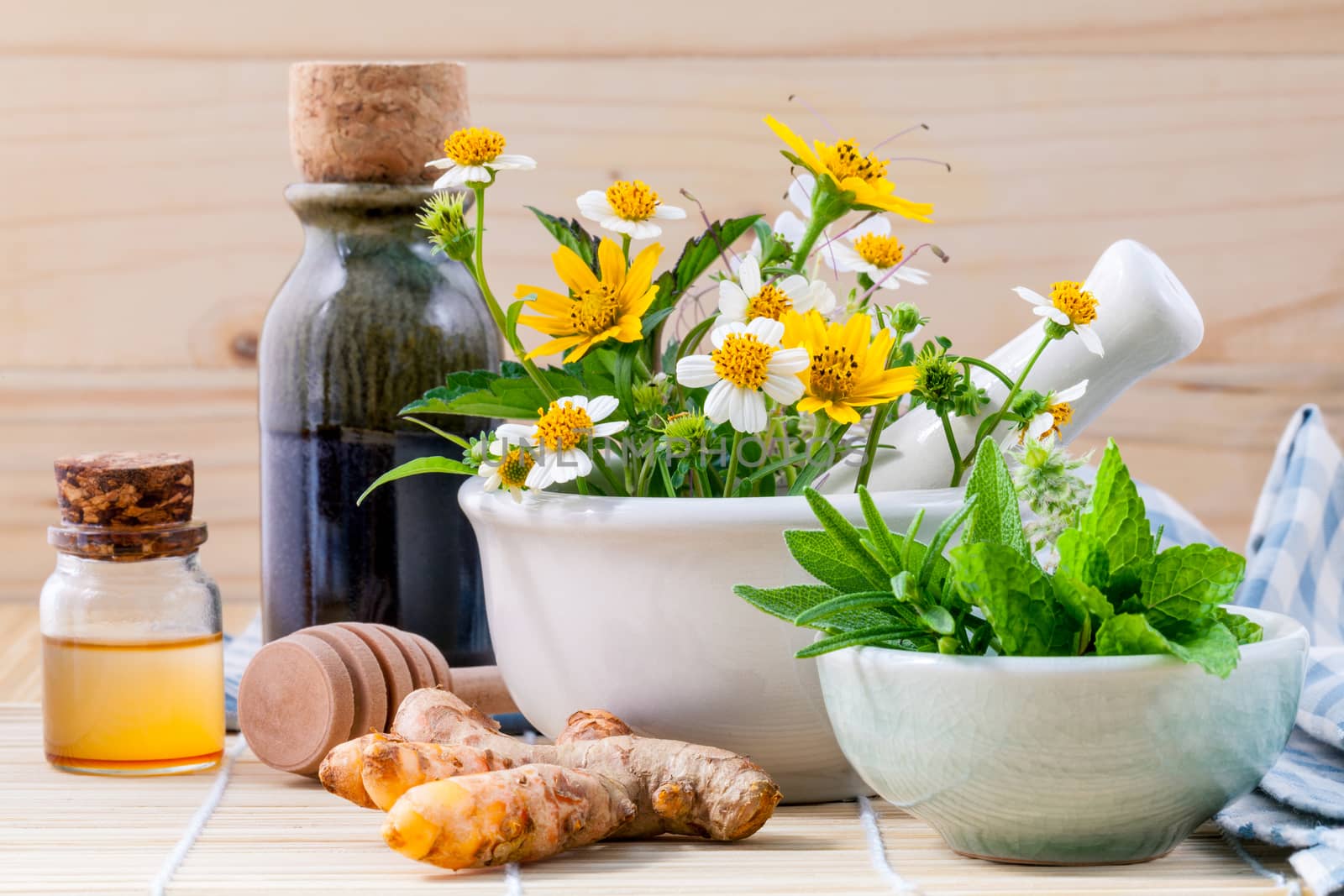 Alternative health care fresh herbal ,honey and wild flower with mortar on wooden background.