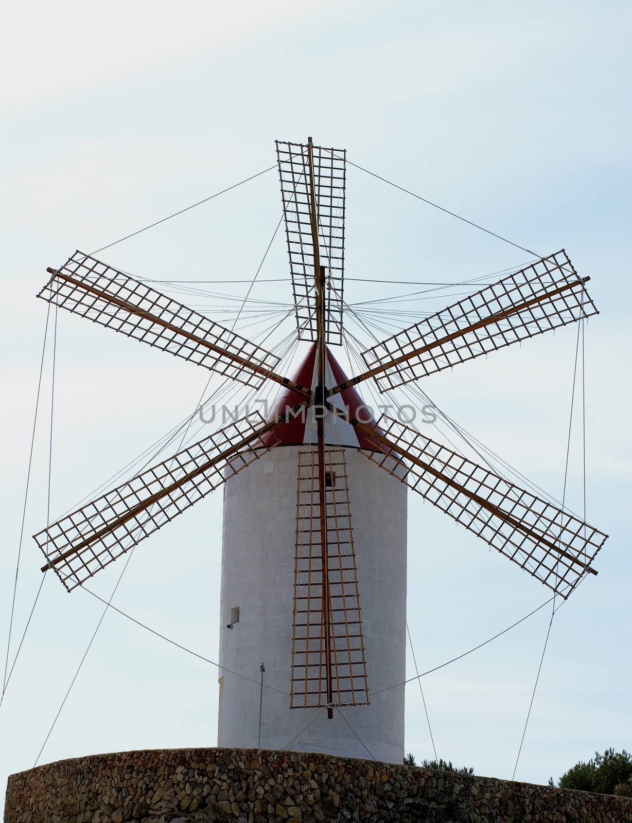 Beautiful Old Rustic Windmill on Cloudy Sky background Outdoors, Menorca, Balearic Islands