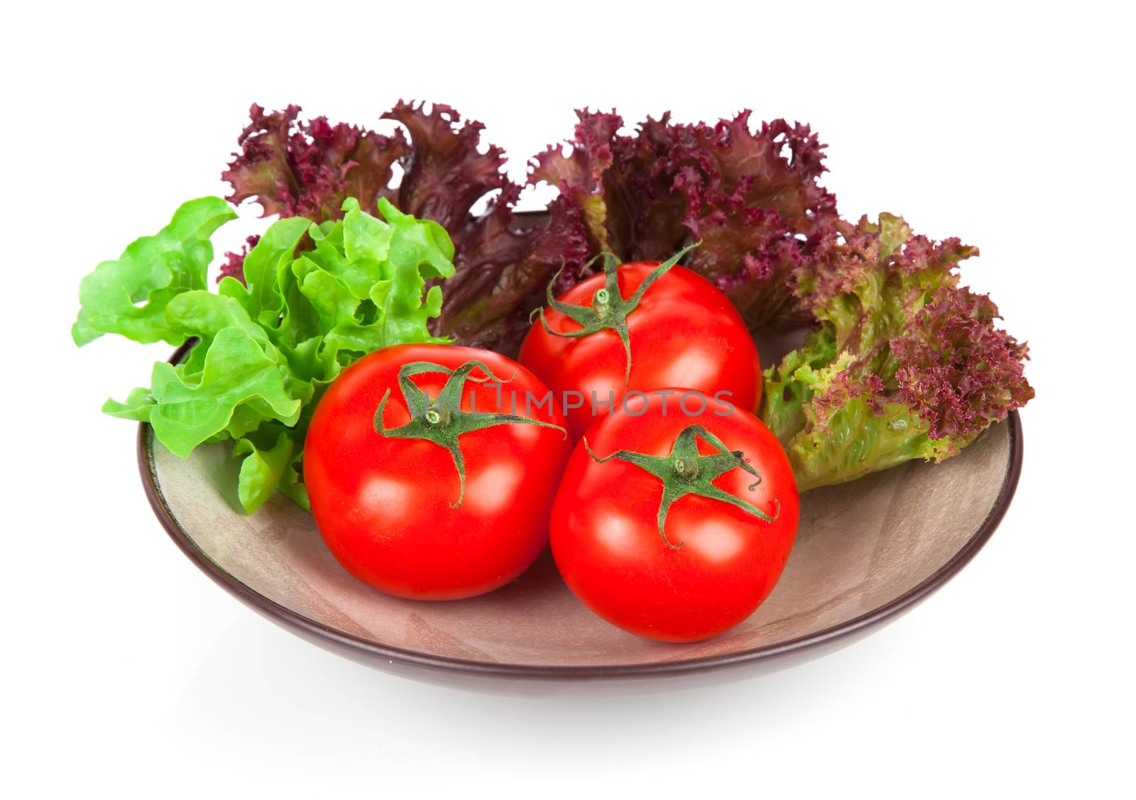 Ripe tomatoes in bowl and basil. Isolated on white background