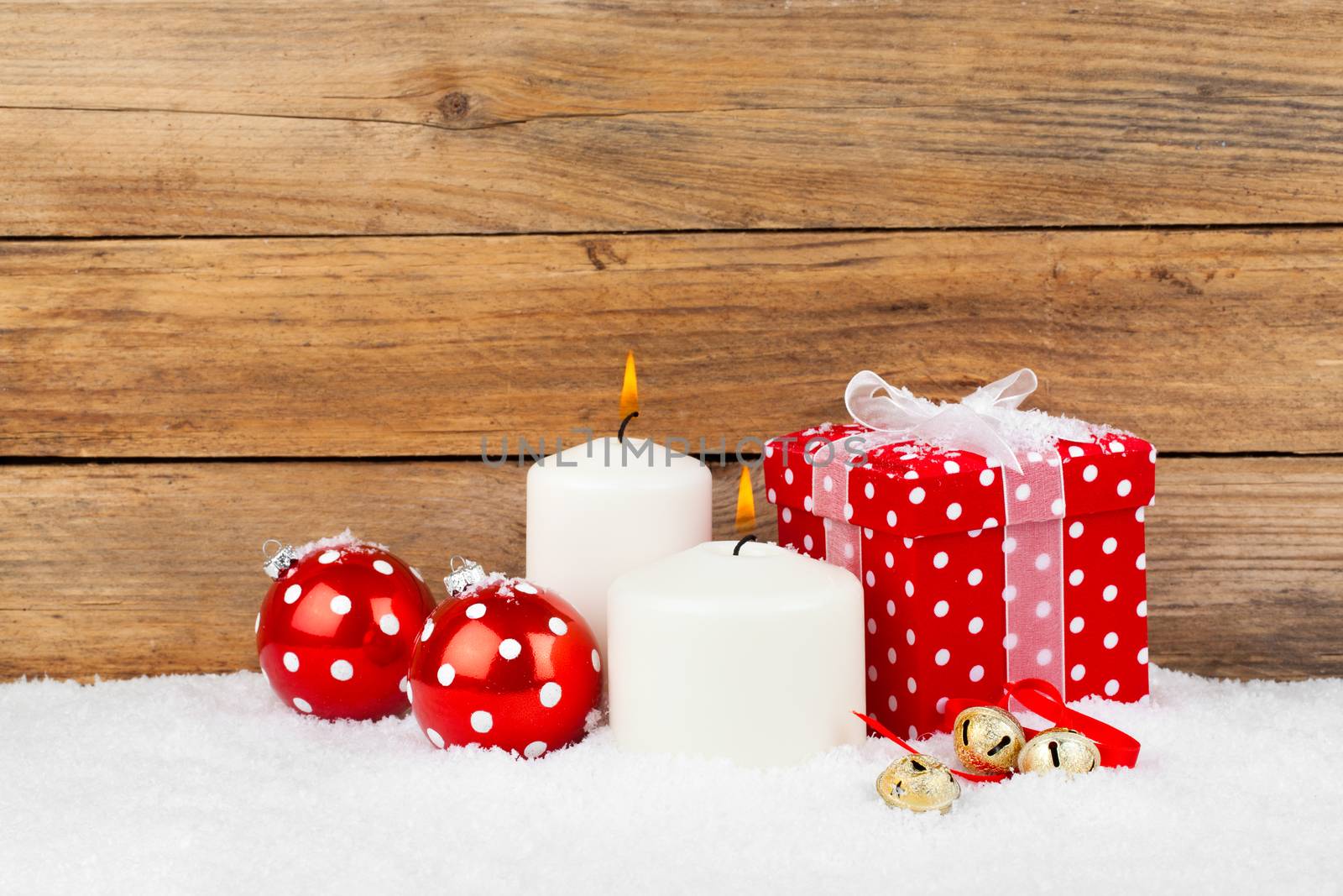 christmas red gift with snow, on wooden background by motorolka