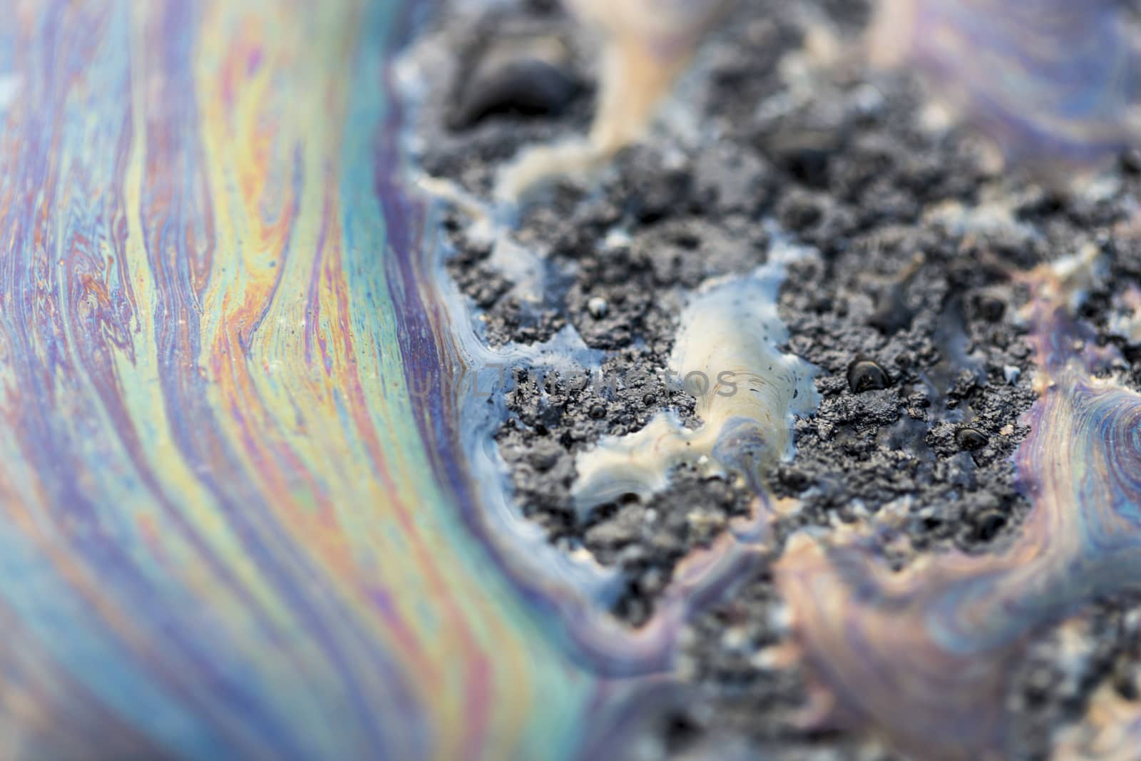 Gasoline Spill on Asphalt close u macro image.