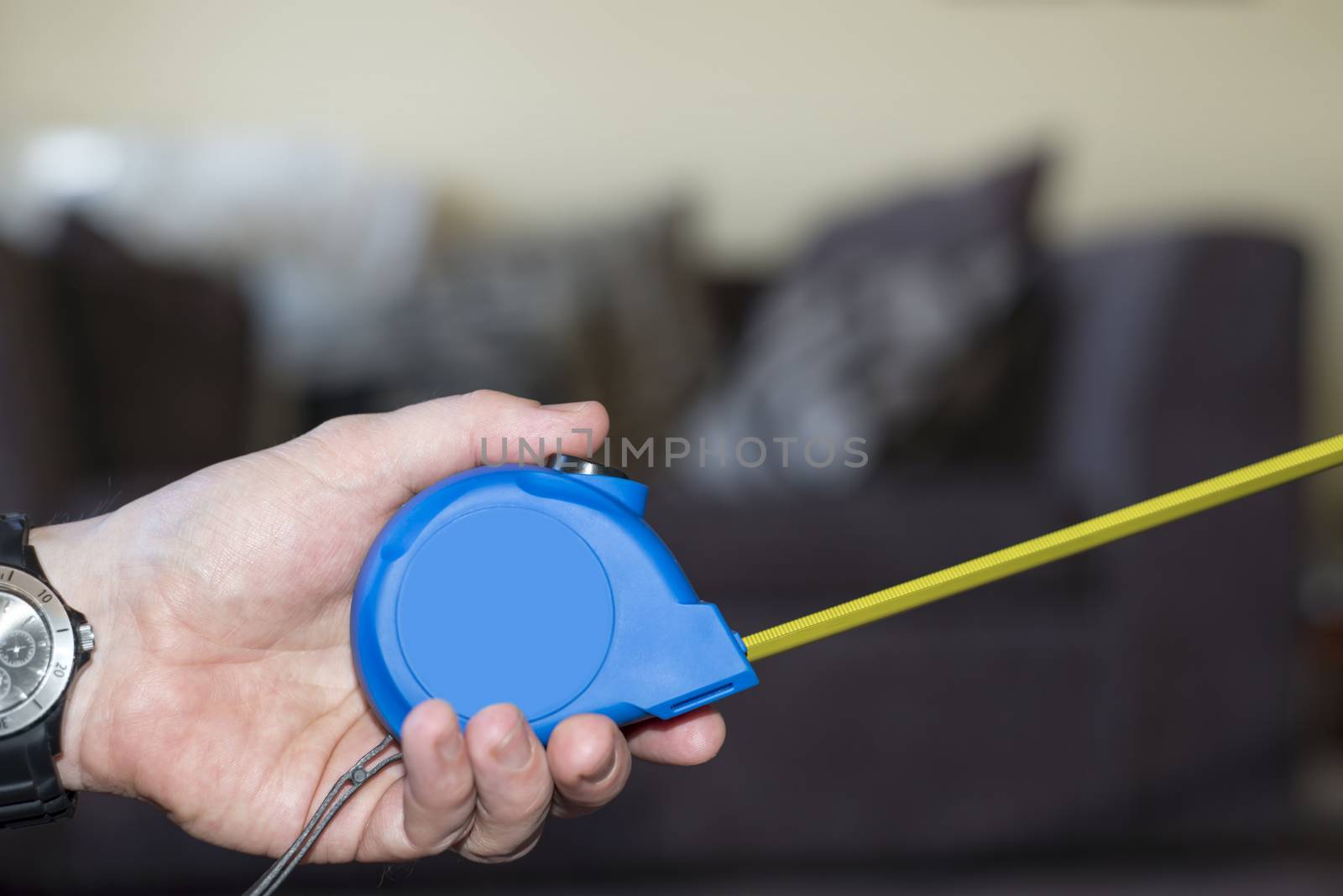 measuring tape in hand by morrbyte