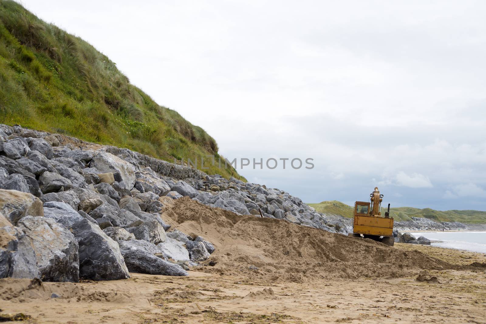 mechanical excavator working on coastal protection for the ballybunion golf course in ireland