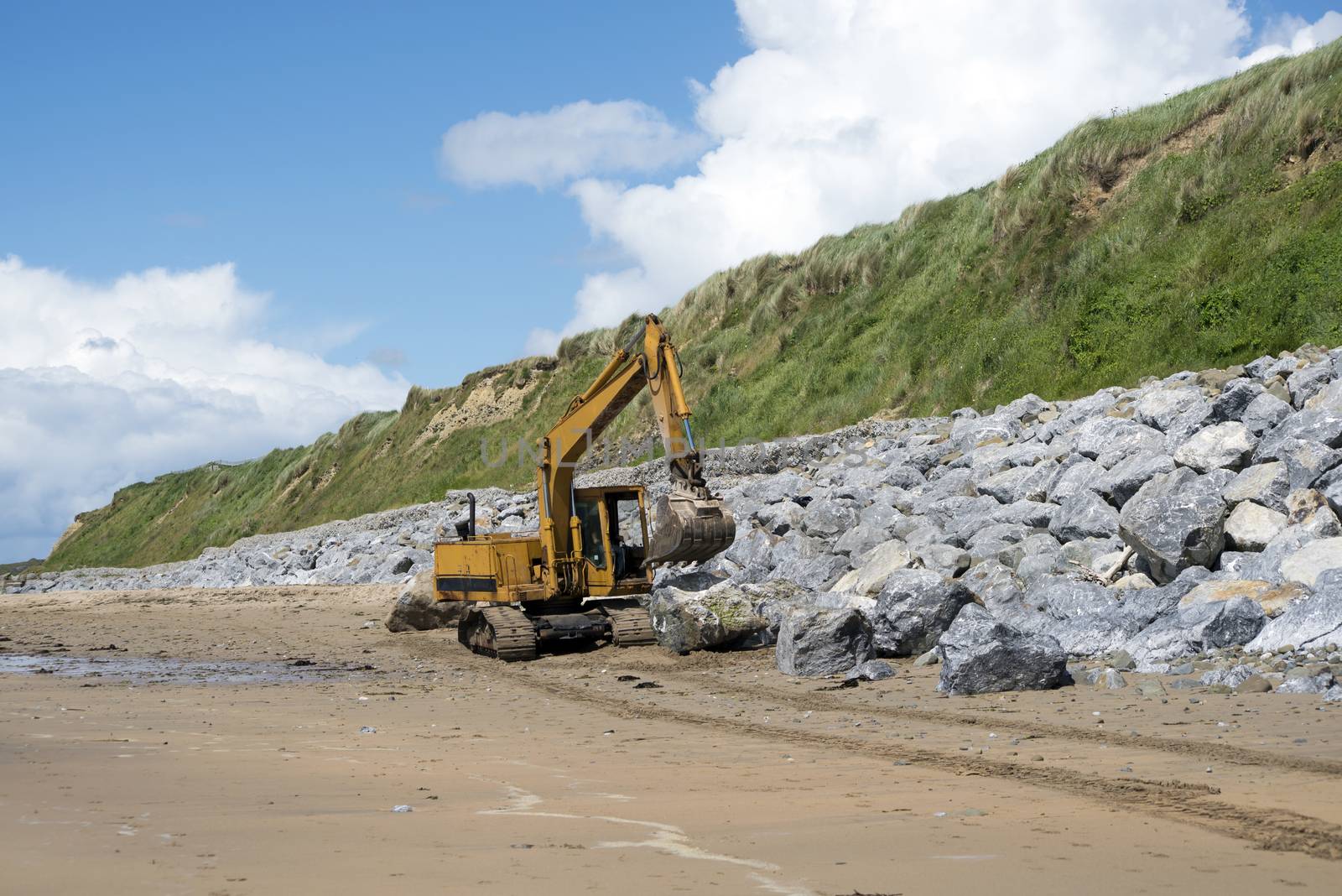 mechanical excavator working on coastal protection for the ballybunion golf course in ireland