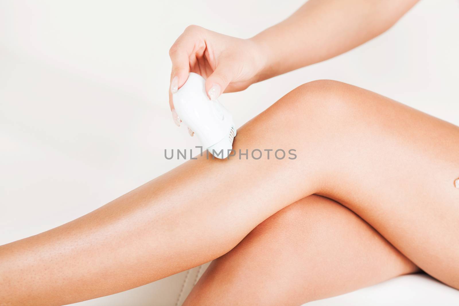 Woman shaving leg with Electric Razor