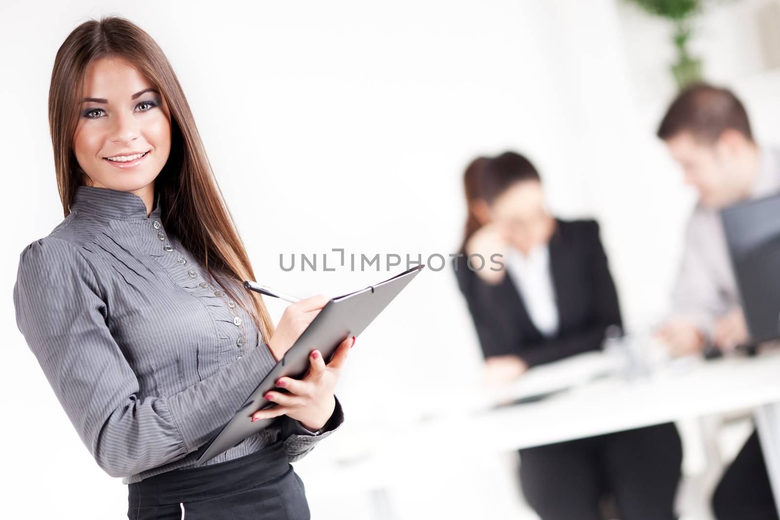 Happy Businesswoman with documents in the office, Looking at camera. Selective Focus.